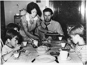 Woman Serving Family Dinner, circa 1955, from the Documentary Film, "Emerging Woman", Women's Film Project, 1974