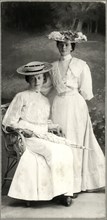 Two Women in White Dresses and Hats, One Seated Holding Parasol, Portrait, Stuttgart, Germany, circa 1900,