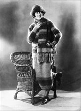 Fashionable Young Woman in Skating Outfit Consisting of Matching Sweater, Skirt, Scarf and Hat Made of Angora Wool, Portrait, circa 1922