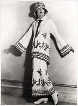 Fashionable Woman in Two-Piece Outfit of White Twill, Applique Motifs and Embroidery with Hat, Portrait, circa 1922