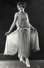 Fashionable Young Woman in Long Dress of Crepe Chiffon with Silver Petals and Matching Headband, Portrait, circa 1922