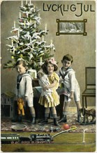 Three Children with Presents and Train Set in Front of Christmas Tree, "Lycklig Jul", Postcard, Sweden, circa 1912