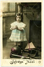 Girl in White and Blue Dress Standing next to Pile of Toys, "Joyeux Noel", Hand-Colored French Postcard