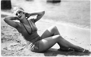 Woman in One-Piece Bathing Suit and Cap Reclining on Beach with Hands Behind Head, French Postcard