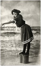 Woman in Dark Swim Dress Standing on Stump in Diving Position, Postcard, circa early 1900's