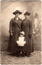 Two Women in Long Coats and Hat with Small Child, Portrait, Postcard, Denmark, circa 1910's