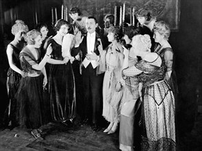 Lew Cody Surrounded by Group of Women, on-set of the Silent Film, "The Beloved Cheater" (aka The Pleasant Devil), 1919