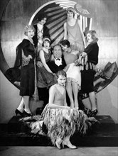 Mack Swain, surrounded by Chorus Girls, on-set of the Silent Film, "Becky", 1927
