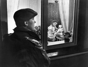 Man Looking at Girl Playing with Doll Through Rainy Window, Claus Holm and Lisa Gussack on-set of the Film, "Bimbo the Great" (aka Rivalen der Manege), 1958