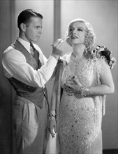 Texas Guinan, having her makeup touched up, on-set of the Film, "Broadway Through a Keyhole",  20th Century Fox Film Corp., 1933