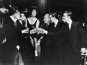 Elizabeth Taylor, Sitting on Bar Amongst Group of Men, on-set of the Film, "BUtterfield 8", 1960