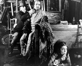 Makeup Artist, (left), attending to Cesare Gravina, Dale Fuller, on-set of the Silent Film "Greed", 1924