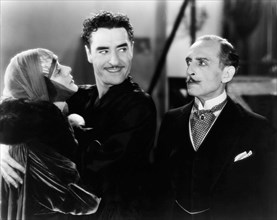 Alma Rubens, John Gilbert, Frank Reicher, on-set of the Silent Film "The Masks of the Devil", 1928