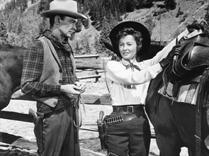 Barry Sullivan, Barbara Stanwyck, on-set of the Film "The Maverick Queen", 1956