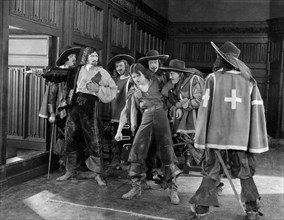 Douglas Fairbanks, (center), on-set of the Silent Film "The Three Musketeers", 1921