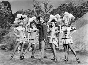 Dan Dailey, with Chorus Girls Marion Marshall, Joyce Mackenzie, Barbara Smith, Marilyn Monroe, on-set of the Film "A Ticket to Tomahawk", 1950