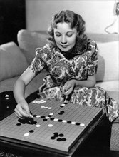 Actress Una Merkel, Portrait, Playing Chinese Checkers, late 1930's