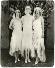 Portrait of Three Unidentified Actress in Fashionable Long Dresses with Uneven Hemlines, circa 1925