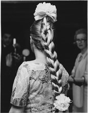 Woman with Fashionable Long Braid Entwined with Ribbon and Large Flowers Decorating the Crown and End of Braid, 1965