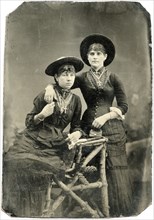 Portrait of Two Adult Women, Wearing Crucifixes, Hats and Holding Hands, Tintype, circa 1870