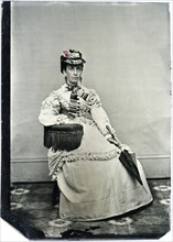 Portrait of Seated Adult Woman Wearing Hat and Holding Parasol, Hand-Colored Tintype, circa 1870