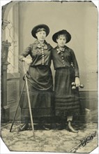 Portrait of Two Young Adult Women, Both Standing in Hats and Long Skirts with Poles, Rings and  Weights, circa 1870