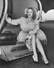 Marlene Dietrich, Publicity Portrait, Sitting on Steps of TWA Airplane en route to Hollywood from New York City, New York, USA, 1946