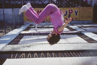 Girl Flipping on Amusement Park Trampoline, Coney Island, New York, USA, August 1961