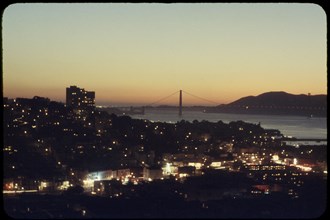Illuminated Cityscape with Golden Gate Bridge in Background at Sunset, San Francisco, California, USA, 1957