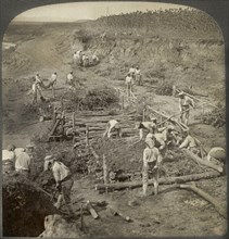Japanese building a bridge of poles across a stream for the passage of troops in Manchuria, Single Image of Stereo Card, Underwood & Underwood, 1906