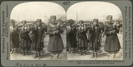 Quaint Dairy Maids Delivering Milk in Earthenware Jars Suspended on Poles, Kiev, Russia, Stereo Card, Keystone View Company