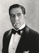 Actor Robert Warwick, Head and Shoulders Publicity Portrait Wearing Tuxedo and Smoking Cigarette, 1930's