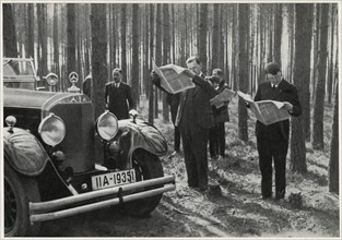 Adolf Hitler and Entourage Standing Alongside his Mercedes while Reading Newspapers in the Woods, Germany, early 1930's