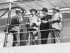 U.S. President Franklin Roosevelt (2nd Left) aboard USS Houston with (L-R) Assistant Secretary Marvin McIntyre, his son James Roosevelt and Secretary of the Interior Harold Ickes, upon Warship's Arriv...