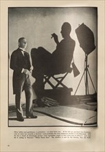 Actor Erich Von Stroheim, Shadow of Director Roy del Ruth, Portrait on-set of Film, "Three Faces East, Warner Bros., inside The New Movie Magazine, May 1930