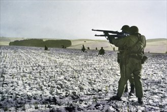 Infantrymen Fire at German Troops in Advance to Relieve Surrounded Paratroopers, Bastogne, Belgium, Ardennes-Alsace Campaign, Battle of the Bulge, December 1944