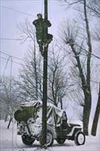 Signal Corps Lineman Repairing Damaged Telephone Lines, Ardennes-Alsace Campaign, Battle of the Bulge, 1945