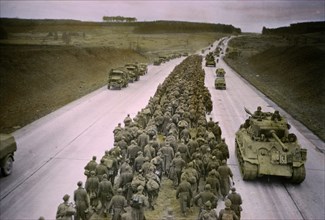 Armored Troops Moving to the Front as Prisoners are Marched along Autobahn to the Rear, Central Europe Campaign, Western Allied Invasion of Germany, 1945