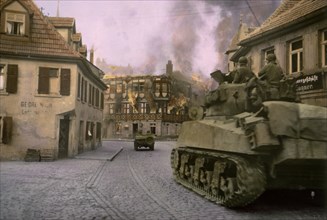 Vehicles of Armored Division Passing through Burning German Town, Central Europe Campaign, Western Allied Invasion of Germany, 1945