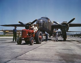 B-25 Bomber Planes Being Hauled along Outdoor Assembly Line by Tractor, North American Aviation, Inc., Kansas City, Kansas, USA, Alfred T. Palmer for Office of War Information, October 1942