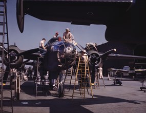 Employees on the "Sunshine" Assembly Line Putting Finishing Touches on B-25 Bomber, North American Aviation, Inc., Inglewood, California, USA, Alfred T Palmer for Office of War Information, October 19...