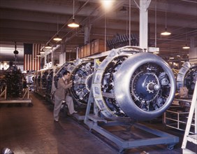 Cowling and Control Rods being added to Motors of B-25 Bombers as they Move Down Assembly Line, North American Aviation, Inc., Inglewood, California, USA, Alfred T Palmer for Office of War Information...