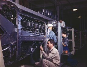 Workers Assembling Cowling on Allison Motors for P-51 Fighter Planes, North American Aviation, Inc., Inglewood, California, USA, Alfred T Palmer for Office of War Information, October 1942