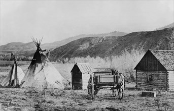 Two Tipis, Small Wood Buildings and Buggy, Hills in Background, Colville Agency, Washington, USA, National Photo Company, 1910
