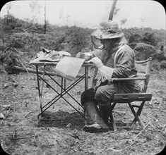 Theodore Roosevelt, Seated at Folding Table, Writing during Roosevelt-Rondon Scientific Expedition, Brazil, December 1913