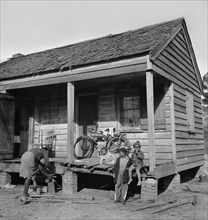 Family on Porch of Rural Cabin, near Charleston, South Carolina, USA, Marion Post Wolcott, Farm Security Administration, December 1938
