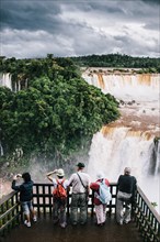 Rear View of Group of Tourists Viewing Waterfalls, Foz do Iguacu, Brazil