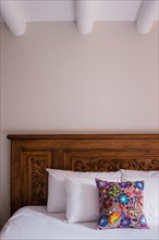 Flowered Pillow on Wood Bed