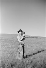 Cowboy with Amateur Movie Camera, Quarter Circle U Roundup, Montana, USA, Arthur Rothstein, Farm Security Administration, June 1939