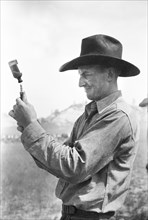 Cowboy Filling Syringe with Blackleg Serum, Quarter Circle U Ranch Roundup, Montana, USA, Arthur Rothstein, Farm Security Administration, June 1939